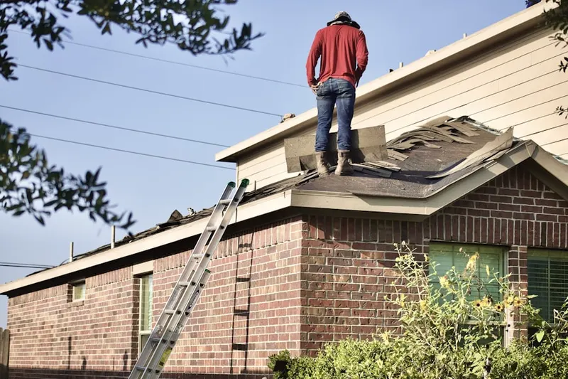 Professional roofer working on a residential roof in Chrome